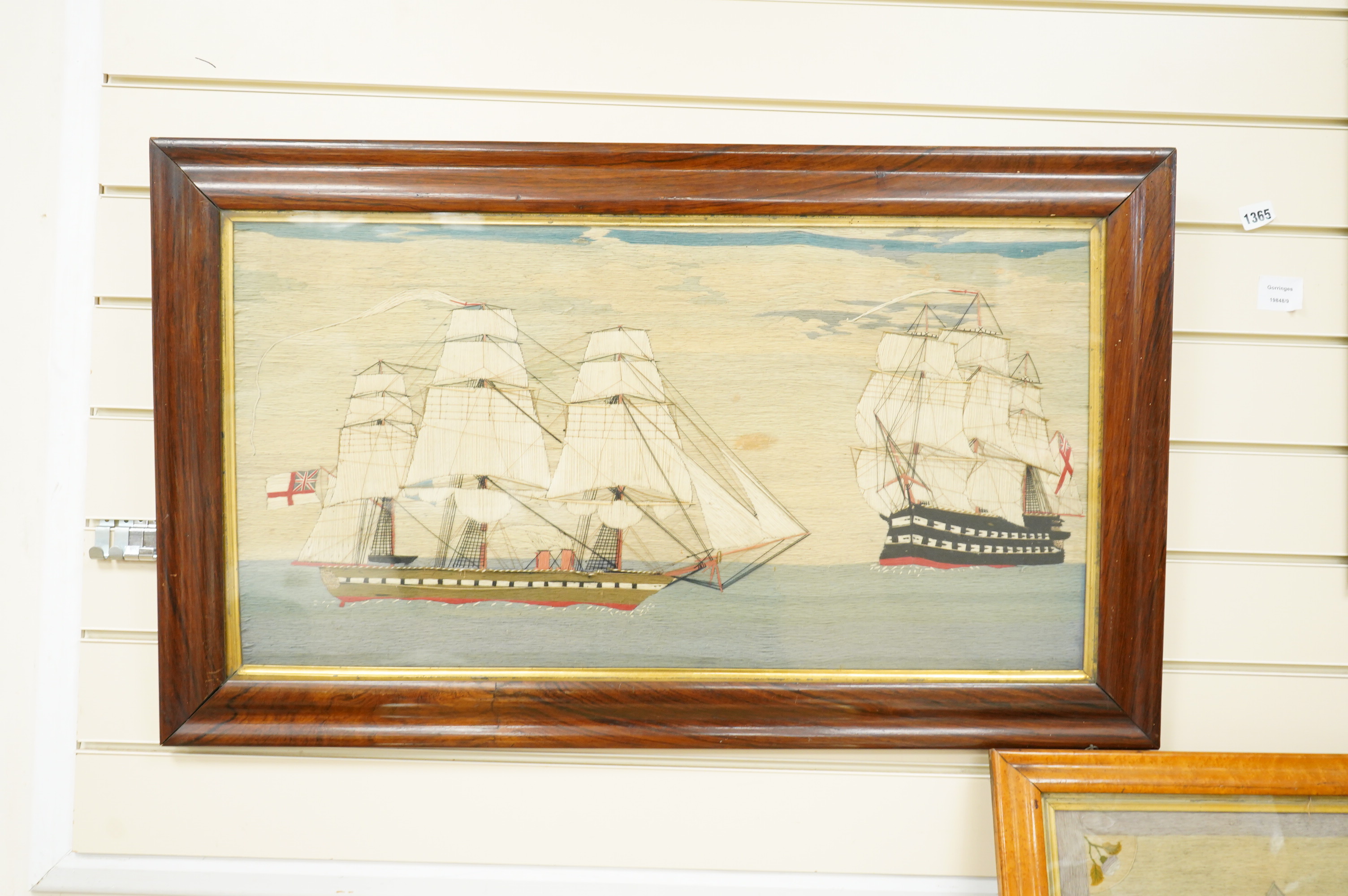 A large 19th century folk art ‘sailors woolie’ embroidery, of a naval steam ship and a frigate, both flying the Royal Navy ensign. 74cm x 39cm.